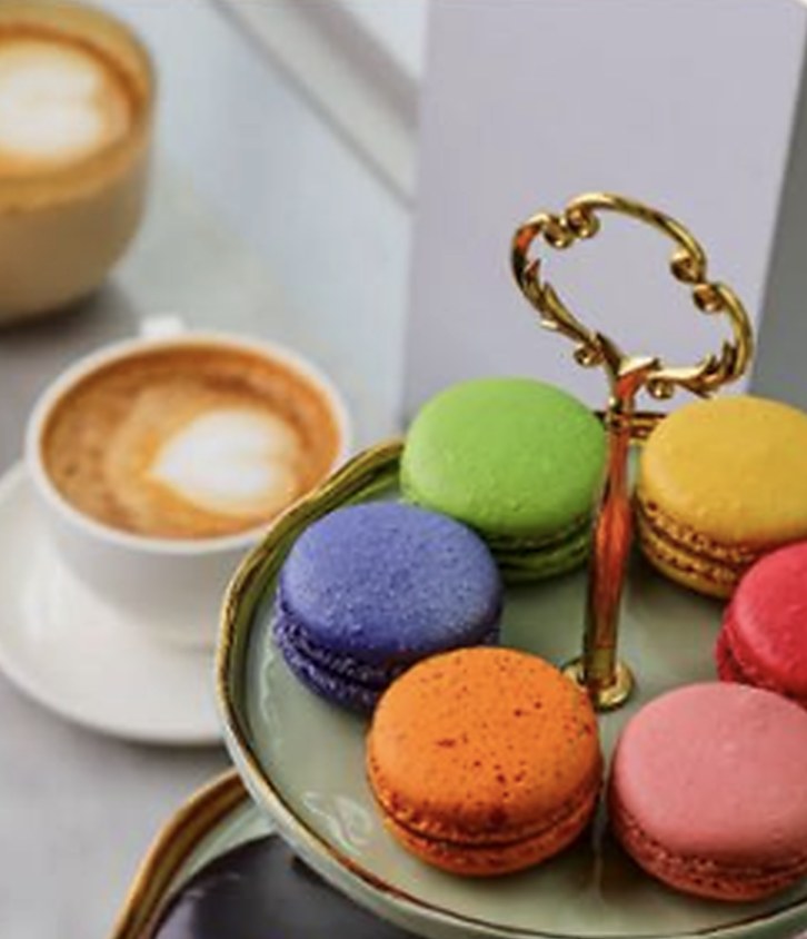 Coffee, colorful Praliné macarons, and the campaign’s ornate golden key
