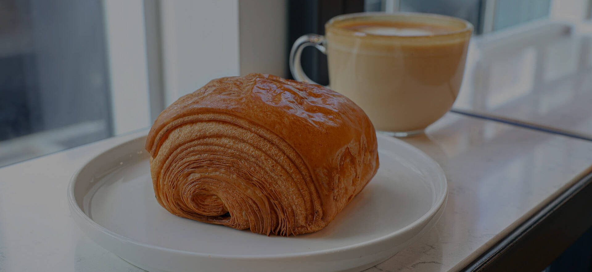 Golden Praliné viennoiserie with coffee